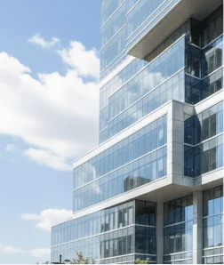 Modern glass high-rise building against a blue sky